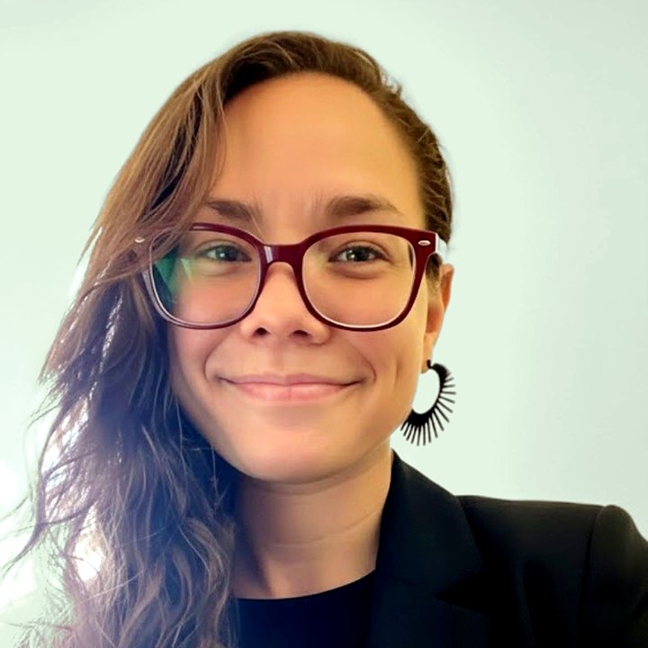 Melissa Rivera, LCSW, smiling, wearing dark-framed glasses and a black blazer